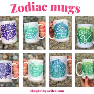 May include: Set of 10 white ceramic mugs with zodiac signs and personality traits printed on them. The mugs are green, blue, and purple with white lettering. The mugs are arranged in two rows of five.