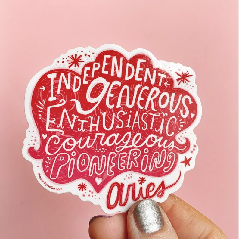 May include: Red and white sticker with the words "Independent, Generous, Enthusiastic, Courageous, Pioneering" and "Aries" in a stylised font. The sticker is in the shape of a cloud.