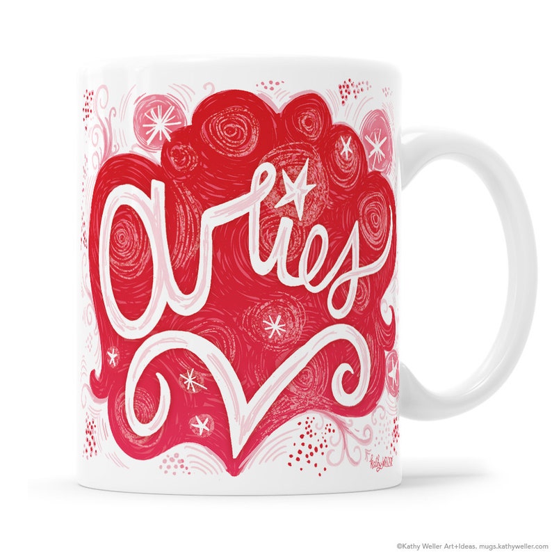 May include: White ceramic mug with a red and pink design featuring the word "Aries" in a stylized font. The design includes swirls, stars, and dots.