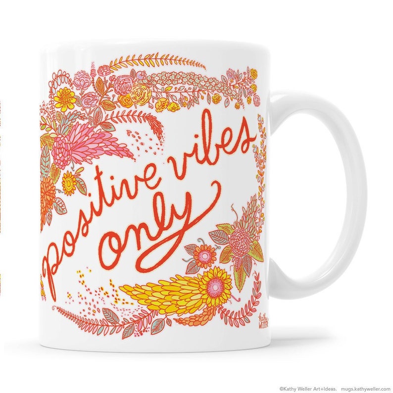 May include: White ceramic coffee mug with a floral design and the text "positive vibes only" in red.