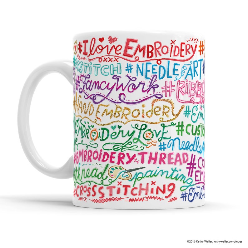 May include: White ceramic mug with a colorful design featuring the words "I love embroidery", "stitch", "fancy work", "hand embroidery", "embroidery love", "custom", "needle", "embroidery thread", "cross stitching", and more.