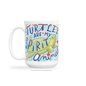 May include: White ceramic mug with a colorful illustration of a turtle and the text "Turtles are my spirit animal".