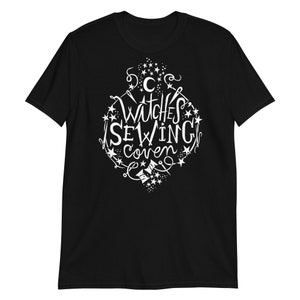 May include: Black t-shirt with a white graphic design that says "Witches Sewing Coven" with stars and sewing-related imagery.