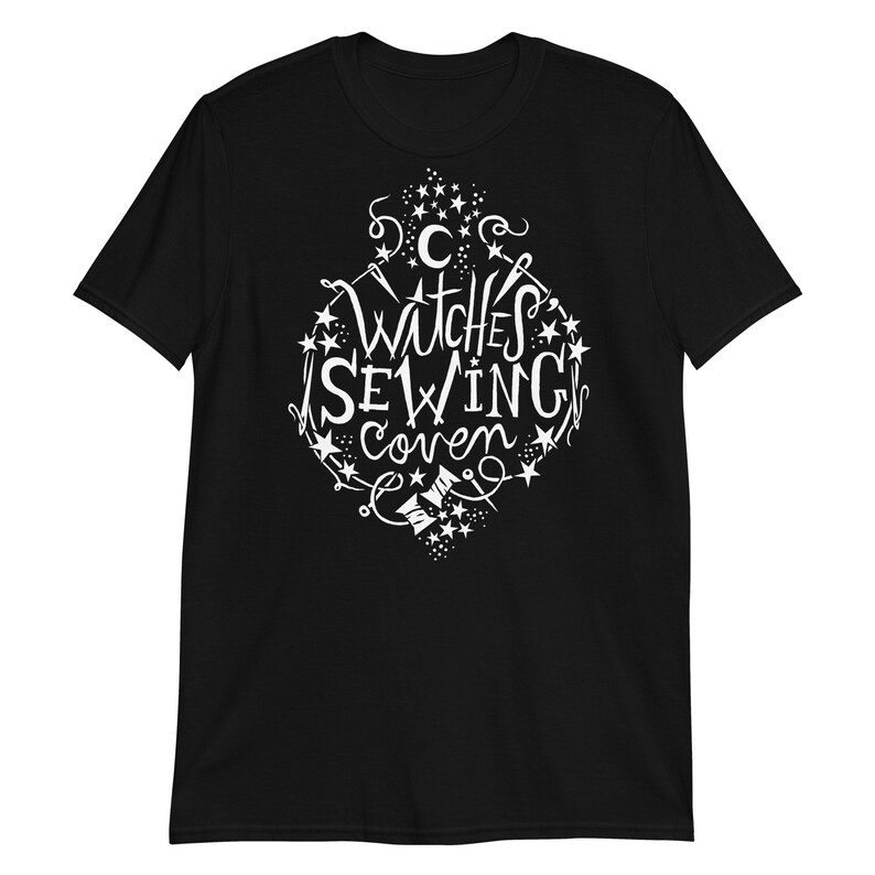 May include: Black t-shirt with a white graphic design that says "Witches Sewing Coven" with stars and sewing-related imagery.