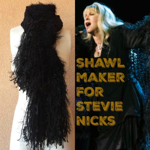 May include: A black shawl with long fringe, similar to one worn by Stevie Nicks. The text "SHAWL MAKER FOR STEVIE NICKS" is superimposed on the image.