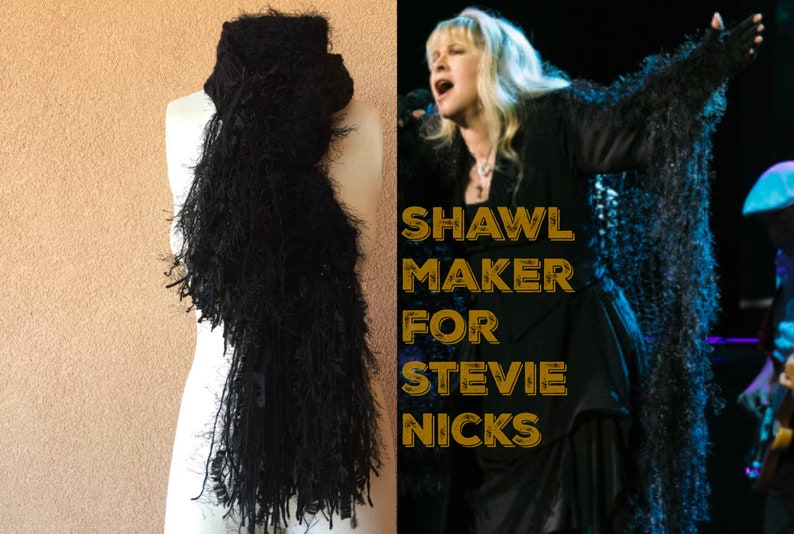 May include: A black shawl with long fringe, similar to one worn by Stevie Nicks. The text "SHAWL MAKER FOR STEVIE NICKS" is superimposed on the image.
