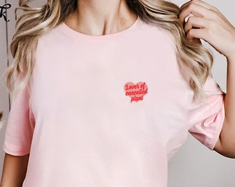 May include: A pink t-shirt with a red heart graphic that says "Lover of cancelled plans".