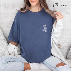 May include: An oversized blue t-shirt with a white outline of Mickey Mouse on the left chest.