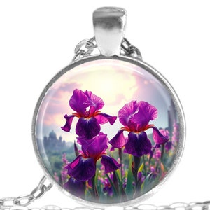 May include: A silver necklace with a round glass pendant featuring a close-up image of purple irises in a field. The pendant has a silver rim and the necklace has a silver chain.