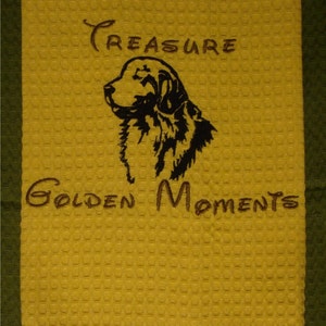 May include: Yellow kitchen towel with black embroidered image of a golden retriever and the text "Treasure Golden Moments".