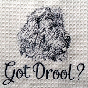 May include: A white kitchen towel with a black embroidered image of a dog's head and the text "Got Drool?"