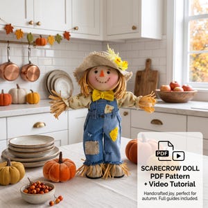 May include: A scarecrow doll wearing a straw hat with yellow flowers, a yellow bow tie, and blue denim overalls with patches. The doll has yarn hair, a stitched smile, and orange nose. Text on the image reads: PDF SCARECROW DOLL PDF Pattern + Video Tutorial.