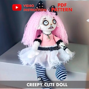 May include: A creepy cute doll with pink yarn hair, a black and white polka dot dress, and striped stockings. The doll is sitting on a white surface. The image includes the text "VIDEO INSTRUCTION" and "PDF PATTERN".