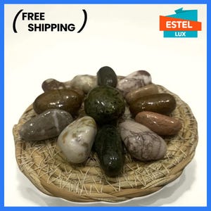 Set of decorative sea stones coated with epoxy resin in a wicker bowl Eco-friendly craft Natural sea stones for various crafts kitchen decor