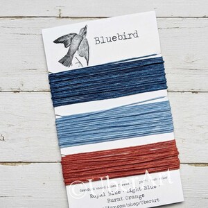 May include: A card with three spools of waxed linen thread in shades of blue and orange. The card is labeled "Bluebird" and includes the text "Royal Blue, Light Blue, Burnt Orange" and "www.Etsy.com/shop/UberArt".