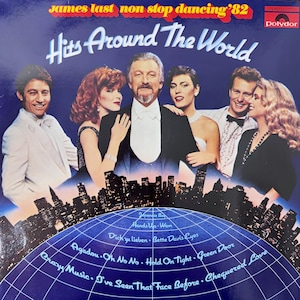 May include: Album cover for James Last's "Hits Around The World" vinyl record. The image shows a group of people in formal wear, with a city skyline at the bottom. The album title and artist name are displayed at the top.