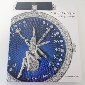 May include: A book cover featuring a watch design with a blue face and a diamond-encrusted bezel. The watch face has a silver figure and the text "Van Cleef & Arpels Le Temps poétique". The book is on a white background.