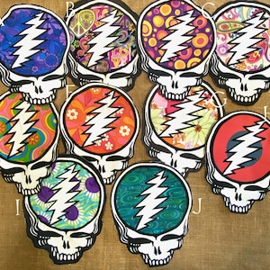 May include: Ten colourful iron-on patches featuring a skull with a lightning bolt design. Each patch has a different psychedelic pattern, including swirls, dots and paisley.