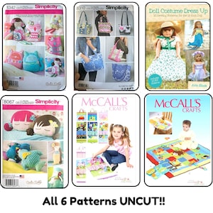 May include: A collection of six uncut sewing pattern envelopes from Simplicity and McCall's Crafts. The patterns feature instructions and illustrations for creating stuffed dolls, fabric bags, doll clothing, and colorful quilted play mats for children.