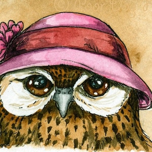 May include: A watercolor painting of an owl wearing a pink hat with a flower on the side. The owl has brown eyes and a brown beak. The background is a light brown.
