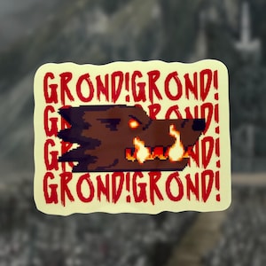 May include: A rectangular sticker featuring a pixelated wolf's head with orange glowing eyes and flames. The sticker has the text "GROND! GROND!" in red, repeated around the wolf image.