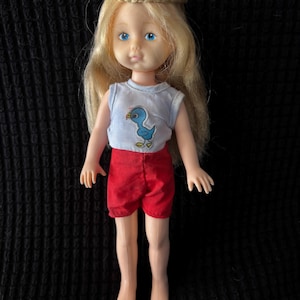 1981/82 Vogue sleepy eye Blonde Ginny with circular braid. Wearing a blue and red romper with a duck decal. Nice used condition. See pics.