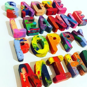 May include: A set of colorful, hand-painted, wax alphabet letters spelling out the names "SADIE", "LEANNE", "POPPY", and "MITH".