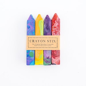 May include: Four colorful crayon stix, made from recycled crayons. The crayon stix are arranged in a row, with the label "Crayon Stix: The Original Rainbow Crayon&reg; Made From Recycled Crayons" visible in the center.