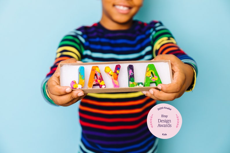 Personalized crayon names featuring Multi-colored crayons in ABC shapes. Crayon shop, Art 2 the Extreme, creates custom crayons in any name! Each crayon letter is easy to hold and features an array of bright colors that blend together.