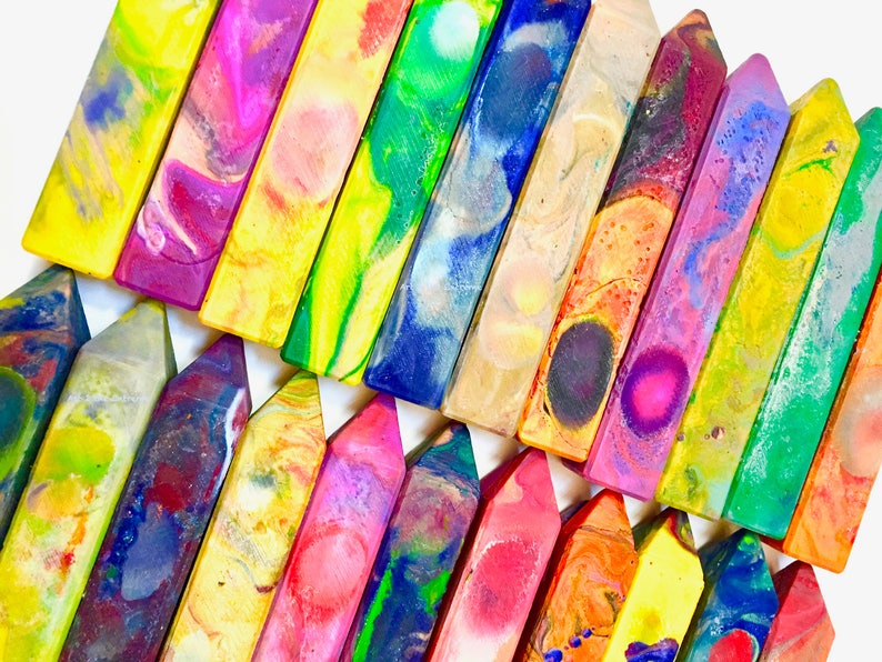 May include: A collection of colorful, swirled crayons arranged in a staggered pattern. The crayons are all different colors and have a unique, marbled appearance.