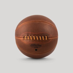 May include: A brown leather basketball with orange stitching and the text "Leatherhead" printed on the side.