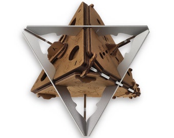May include: A wooden geometric puzzle with a triangular base and a three-dimensional star shape. The puzzle is made of brown wood and has a silver metal frame.
