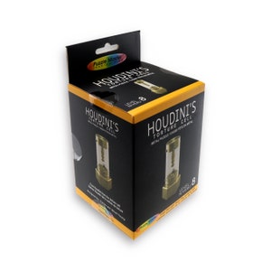 May include: A black box with a yellow label that says "Houdini's Torture Cell" and "Metal Puzzle Cassette en Metal". The box shows a picture of a gold metal puzzle with a clear glass tube. The box is labelled "Level 8".