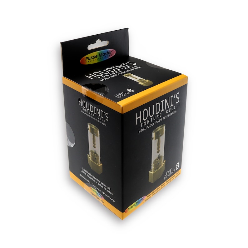 May include: A black box with a yellow label that says "Houdini's Torture Cell" and "Metal Puzzle Cassette en Metal". The box shows a picture of a gold metal puzzle with a clear glass tube. The box is labelled "Level 8".