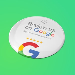 May include: A white, circular button with the Google logo and the text "Review us on Google." The button also features five gold stars and the phrase "Tap phone and review us." An NFC symbol is at the top.