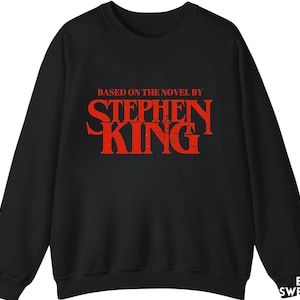 May include: Black sweatshirt with a red graphic that says "Based on the novel by Stephen King".