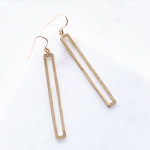 These simple rectangle dangle earrings are made with natural gold color brass. The rectangle dangles have been hammered to add a pretty texture, sealed and polished.