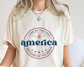 Land der Freien wegen des mutigen Hemdes, Staub des 4. Juli-Geschenks, des amerikanischen Flaggen-T-Stücks, des 4. Juli-T-Shirts, USA-Hemd
