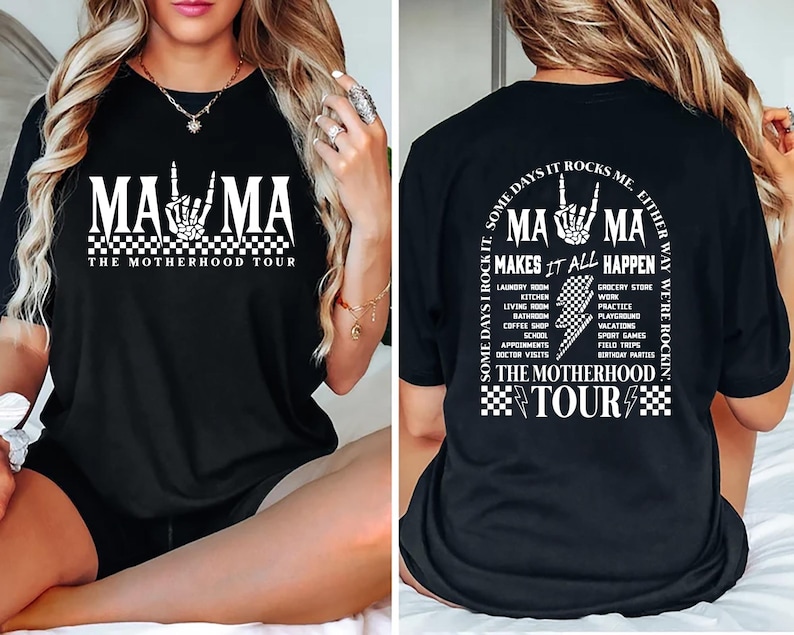 May include: Black graphic tee with the text "MAMA" and a skeleton hand gesture. The shirt also says "THE MOTHERHOOD TOUR" and lists various activities. The back of the shirt has the text "SOME DAYS I ROCK IT, SOME DAYS IT ROCKS ME. EITHER WAY WE'RE ROCKIN".