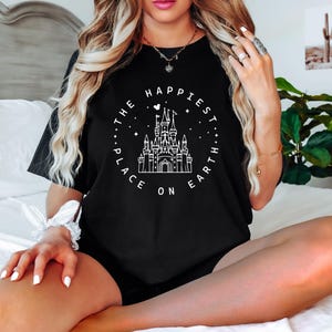 May include: Black t-shirt with a white graphic of Cinderella's castle and the text "The Happiest Place On Earth".