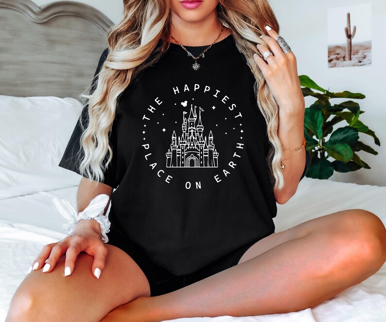 May include: Black t-shirt with a white graphic of Cinderella's castle and the text "The Happiest Place On Earth".