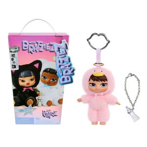 May include: A Bratz doll set featuring two dolls in animal costumes, and a pink duck-themed doll keychain with a silver bottle charm. The Bratz box is pink with the Bratz logo and doll images. The keychain has a silver lip-shaped clasp.