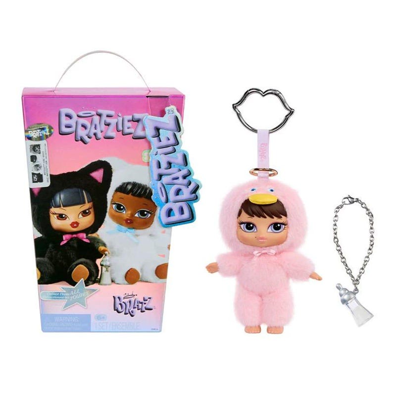 May include: A Bratz doll set featuring two dolls in animal costumes, and a pink duck-themed doll keychain with a silver bottle charm. The Bratz box is pink with the Bratz logo and doll images. The keychain has a silver lip-shaped clasp.