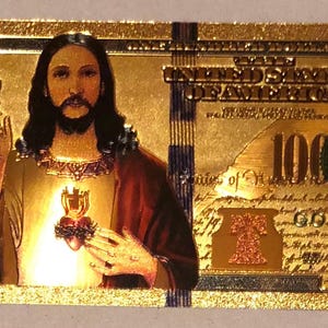 May include: A gold-colored novelty bill featuring an image of Jesus Christ. The bill is marked as "1000000 Gold" and includes various text elements, including the denomination and the words "United States of America."