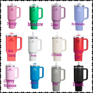 May include: Twelve different colors of stainless steel travel mugs with a handle and a straw. The mugs are labeled with the color names: Peony, Meadow, Lilac, Hydrangea, Hot Coral, Frost, Cream, Chili Red, Cherry Blossom, Azure, Ash, and Black.