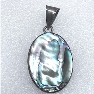 May include: Oval pendant with a shimmering abalone shell design, showcasing iridescent blues, greens, and purples. The pendant is set in a silver-toned metal with a simple bail for a chain.
