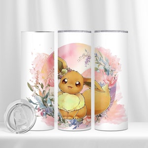 May include: A white stainless steel tumbler featuring a floral design and a cartoon image of Eevee, a Pokemon character, wearing a flower crown. The tumbler comes with a clear lid.
