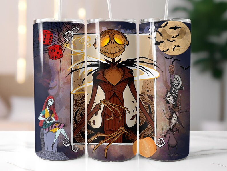 May include: A set of three stainless steel tumblers with a Halloween theme. The tumblers feature a black and white illustration of Jack Skellington from The Nightmare Before Christmas. The tumblers are decorated with a variety of Halloween imagery, including bats, pumpkins, and a full moon.