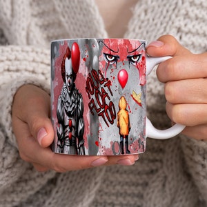 May include: White ceramic mug with a colorful graphic of a clown with red hair and a red balloon, a child in a yellow raincoat, and the text "YOU'LL FLOAT TOO".
