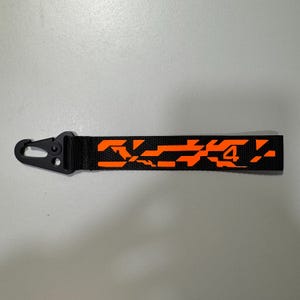 Bolso de mano con diseño de camuflaje de Lando Norris